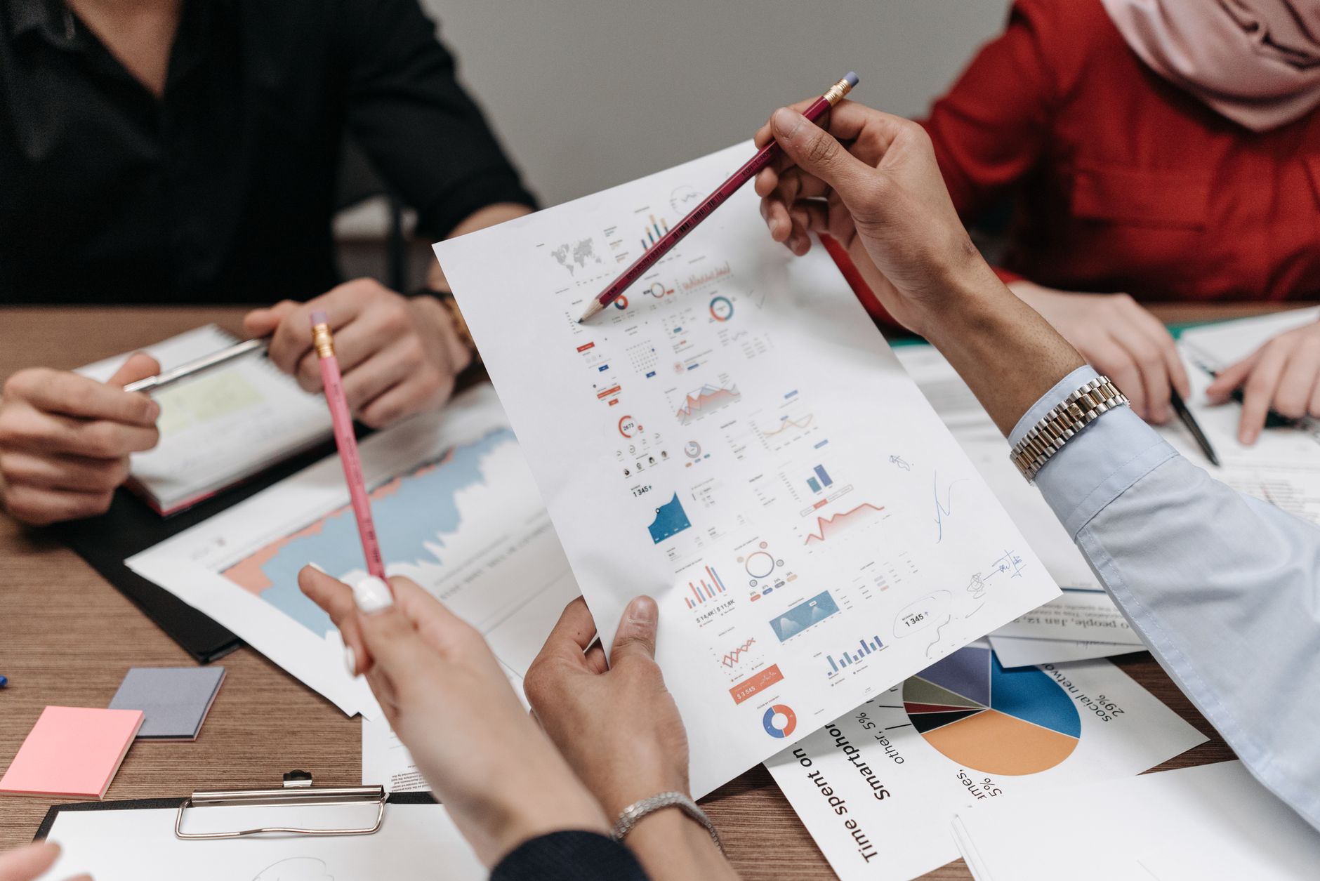 Team analyzing reports with data tools